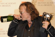 U.S. Actor Mickey Rourke poses after winning the award for Leading Actor for "The Wrestler" during the 2009 BAFTA (British Academy of Film and Television Arts) awards ceremony at the Royal Opera House in London February 8, 2009. REUTERS/Toby Melville (BRITAIN)