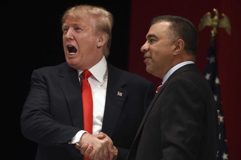 Donald Trump, left, reacts to the crowd as he shakes hands with David Bossie at the 2015 Freedom Summit in Greenville, S.C. 