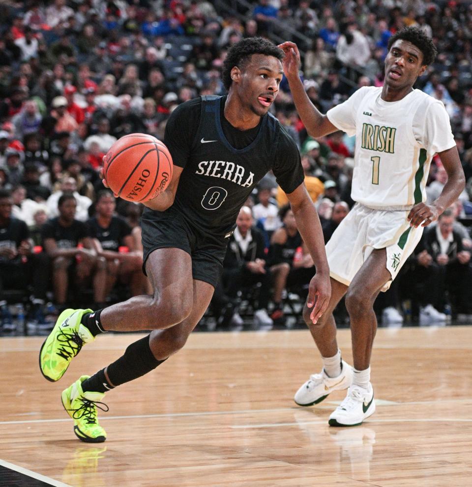 Sierra Canyon’s Bronny James drives against Akron St. Vincent-St. Mary's Lance Hayes during the Ohio Play-by-Play Classic on Dec. 17 at Nationwide Arena.