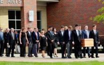 The casket of Otto Warmbier is carried to the hearse followed by his family and friends after a funeral service for Warmbier, who died after his release from North Korea, at Wyoming High School in Wyoming, Ohio, U.S. June 22, 2017. REUTERS/John Sommers II