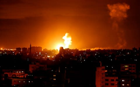 A fireball exploding during Israeli air strikes in Gaza City. - Credit: AP
