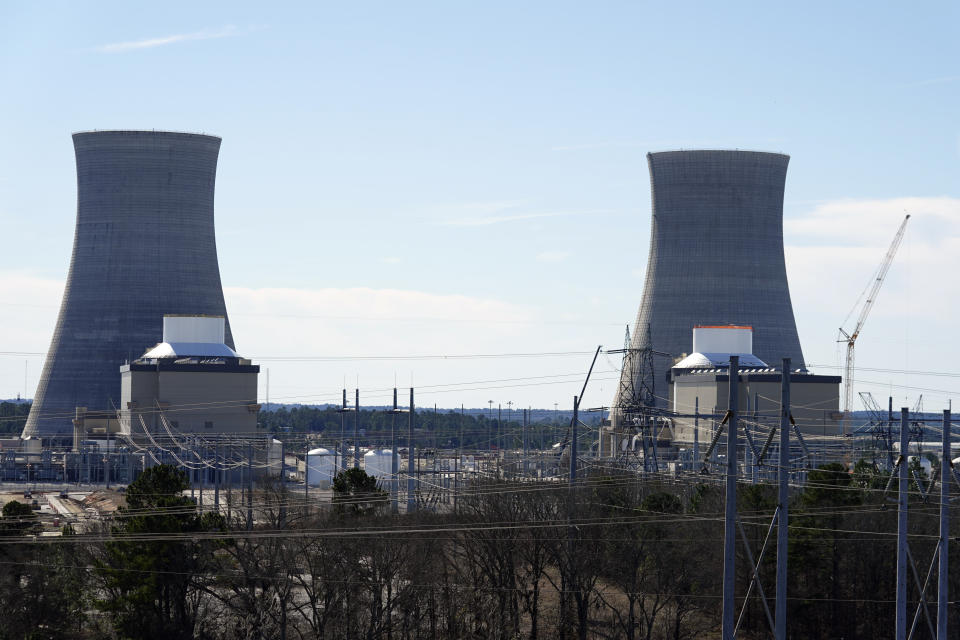 FILE - Units 3, left, and 4 and their cooling towers stand at Georgia Power Co.'s Plant Vogtle nuclear power plant on Jan. 20, 2023, in Waynesboro, Ga. Company officials announced Monday, July 31, 2023, that Unit 3 has reached commercial operation after years of delays and billions in cost overruns. (AP Photo/John Bazemore, File)