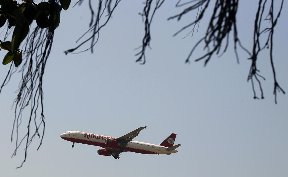 A Kingfisher airlines flight flies in Mumbai, India, Tuesday, March 20, 2012. The severely cash-strapped airlines may now face the risk of cancellation of its flying permit after the Directorate General of Civil Aviation (DGCA) expressed doubts on its ability to maintain a steady schedule with a declining number of operable aircrafts and ongoing problems with pilots leaving the company.(AP Photo/Rafiq Maqbool)