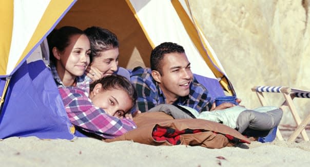 Family camping on sandy beach, California, USA