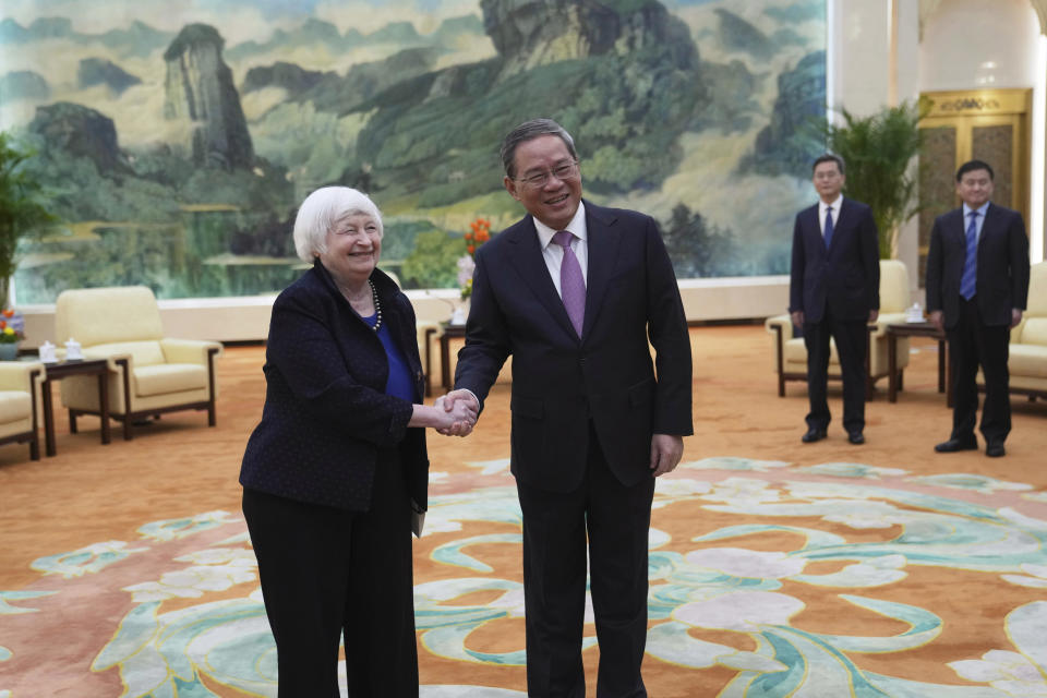 U.S. Treasury Secretary Janet Yellen, left, shakes hands with Chinese Premier Li Qiang at the Great Hall of the People in Beijing, China, Sunday, April 7, 2024. Yellen, who arrived later in Beijing after starting her five-day visit in one of China's major industrial and export hubs, said the talks would create a structure to hear each other's views and try to address American concerns about manufacturing overcapacity in China. (AP Photo/Tatan Syuflana, Pool)