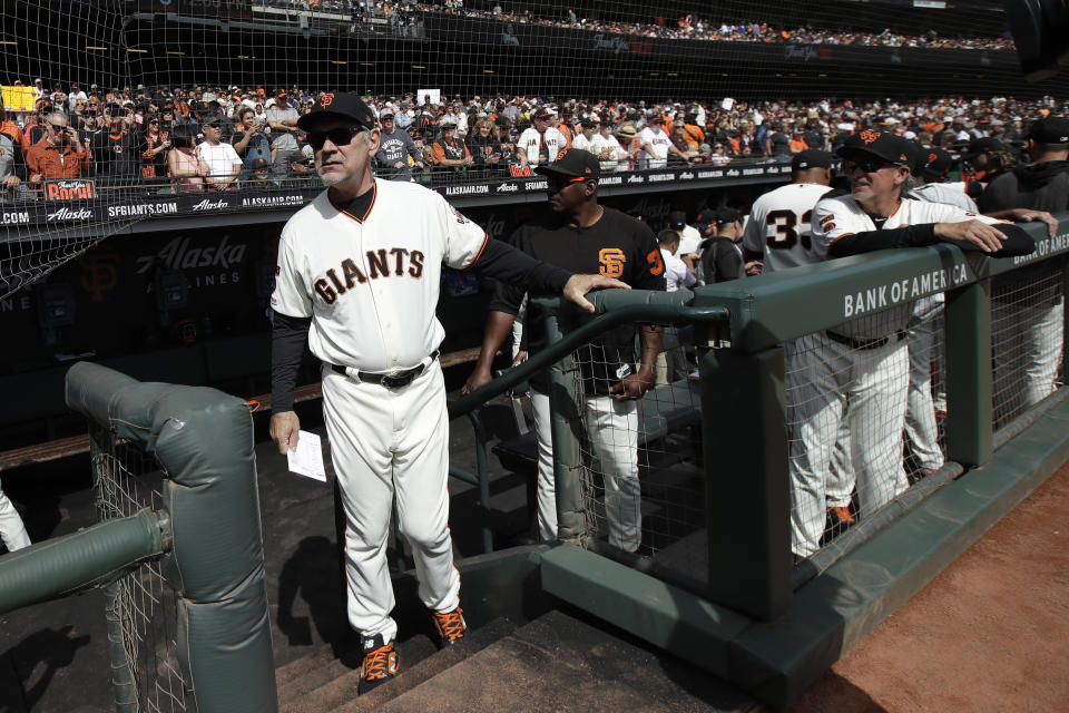 San Francisco Giants manager Bruce Bochy, left, stands in the dugout before a baseball game between the Giants and the Los Angeles Dodgers in San Francisco, Sunday, Sept. 29, 2019. (AP Photo/Jeff Chiu)