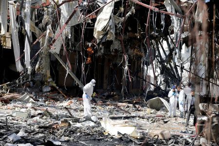 Forensic experts investigate the scene at the community hall where Saudi-led warplanes struck a funeral in Sanaa, the capital of Yemen, October 9, 2016. REUTERS/Khaled Abdullah