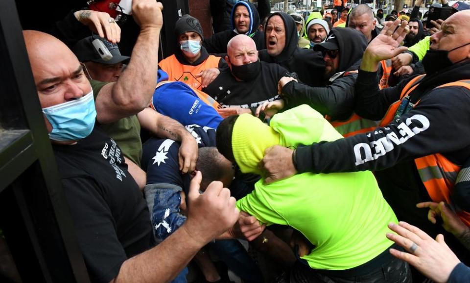 Construction workers clash with unionists at a protest at the CFMEU headquarters in Melbourne on Monday