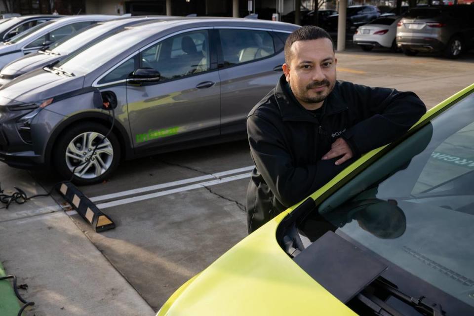 Míocar fleet manager Fernando González stands next to ride sharing electric cars ready for customers in Stockton in December. The nonprofit provides service for low income customers in the Central Valley. Paul Kitagaki Jr./pkitagaki@sacbee.com