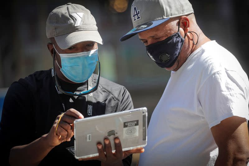 FILE PHOTO: A U.S. Census worker takes the information from a man during a promotional event in Times Square in New York