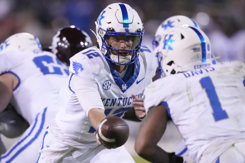 Kentucky quarterback Kaiya Sheron (12) hands off to running back Ray Davis (1) during the second half of the team's NCAA college football game against Mississippi State in Starkville, Miss., Saturday, Nov. 4, 2023. (AP Photo/Rogelio V. Solis)