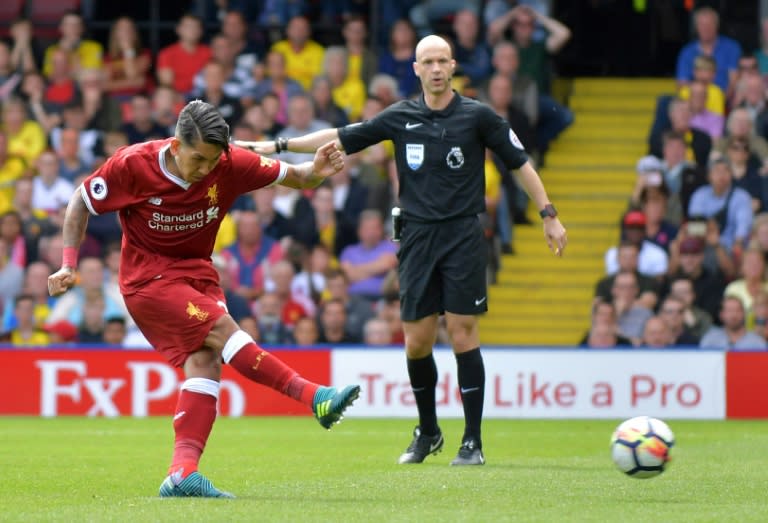 Liverpool's Roberto Firmino shoots from the penalty spot to score his team's second goal, during their English Premier League match against Watford, at Vicarage Road Stadium in Watford, on August 12, 2017