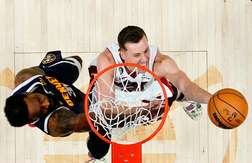 Miami Heat forward Duncan Robinson (55) shoots the ball against Denver Nuggets forward Jeff Green (32) during the second half in Game 2 of the NBA Finals.