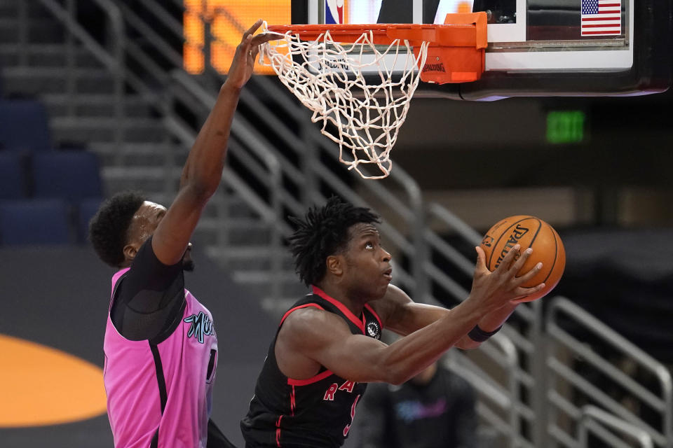 Toronto Raptors forward OG Anunoby (3) goes up for a shot behing Miami Heat center Bam Adebayo (13) during the second half of an NBA basketball game Wednesday, Jan. 20, 2021, in Tampa, Fla. (AP Photo/Chris O'Meara)