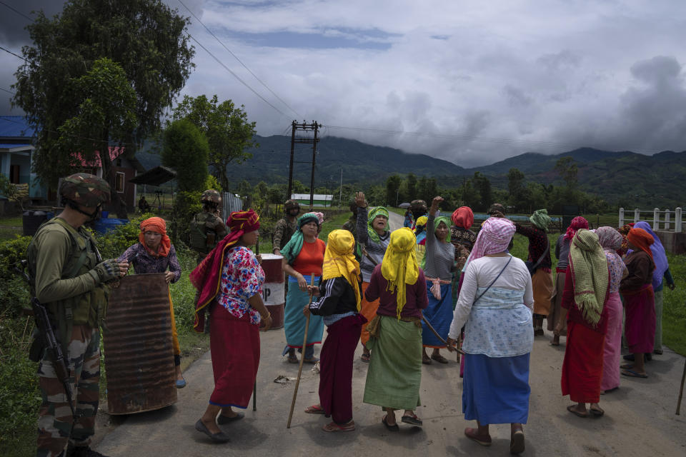 Members of Meira Paibis, powerful vigilante group of Hindu majority Meitei women, try to march toward a site of a gunfight between Meiteis and Tribal Kukis in Kangchup, near Imphal, capital of the northeastern Indian state of Manipur, Thursday, June 22, 2023. Manipur is caught in a deadly conflict between two ethnic communities that have armed themselves and launched brutal attacks against one another. At least 120 people have been killed since May. (AP Photo/Altaf Qadri)