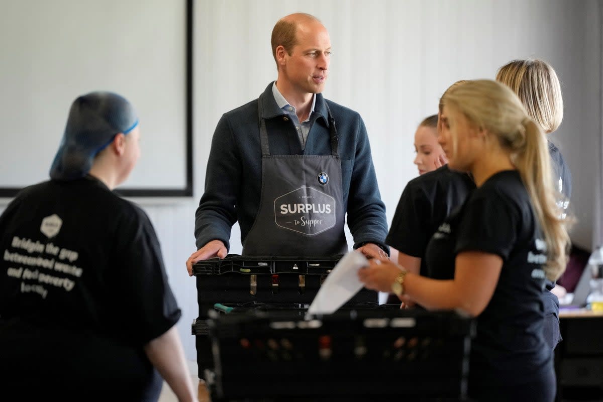 Prince William helps sort out food items for distribution (via REUTERS)