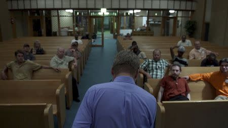 Jay Reinke is shown in this film production still addressing oil-patch workers from his church pulpit in Drafthouse Films' "The Overnighters" in this undated handout photo in Williston, North Dakota, provided by Drafthouse Films October 7, 2014. REUTERS/Drafthouse Films