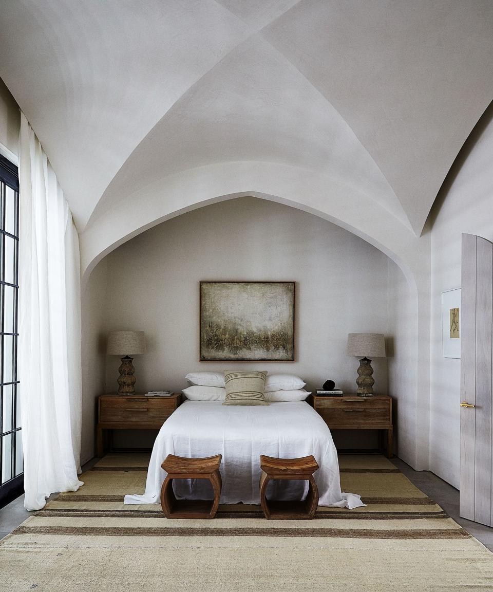 bedroom with white walls and high vaulted ceiling
