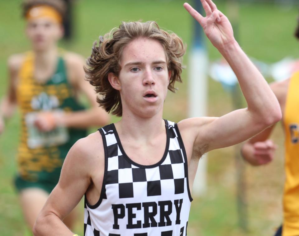 Perry's Logan Reese becomes a state qualifier at last week's regional cross country meet in Bordman.