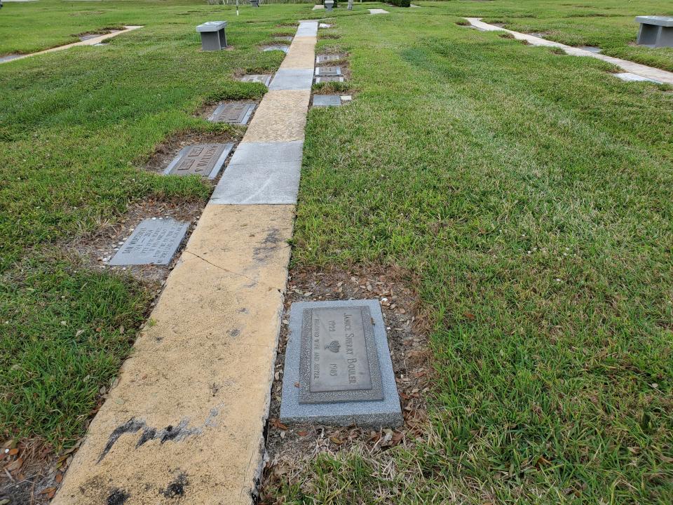 The formerly unmarked graves of Franki, Eric and Joshua Jacobson at Star of David cemetery in Palm Beach Gardens. Graves are the grassy space to the right of the cement path. The three were shot and killed by Neal Jacobson on Jan. 23, 2010.