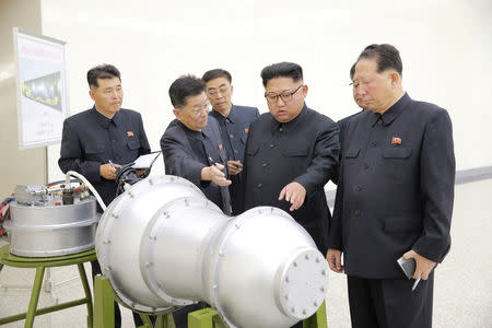 FILE PHOTO - North Korean leader Kim Jong Un provides guidance with Ri Hong Sop (2nd L) and Hong Sung Mu (R) on a nuclear weapons program in this undated photo released by North Korea's Korean Central News Agency (KCNA) in Pyongyang September 3, 2017. KCNA via REUTERS