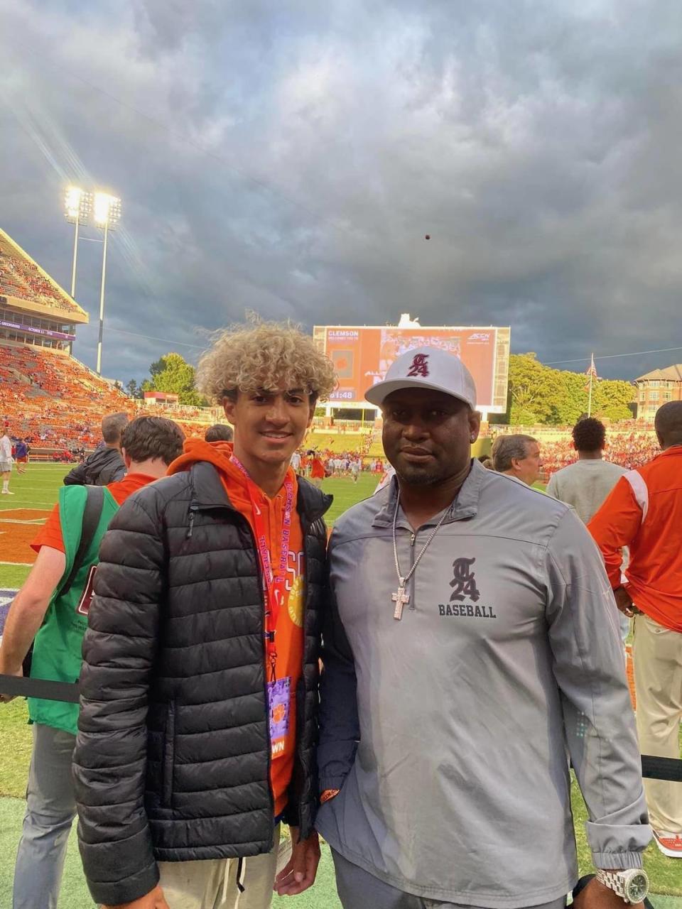 Sheldon Brown (right, all grey) and his son Dion (left, black jacket) attend a Clemson football game.