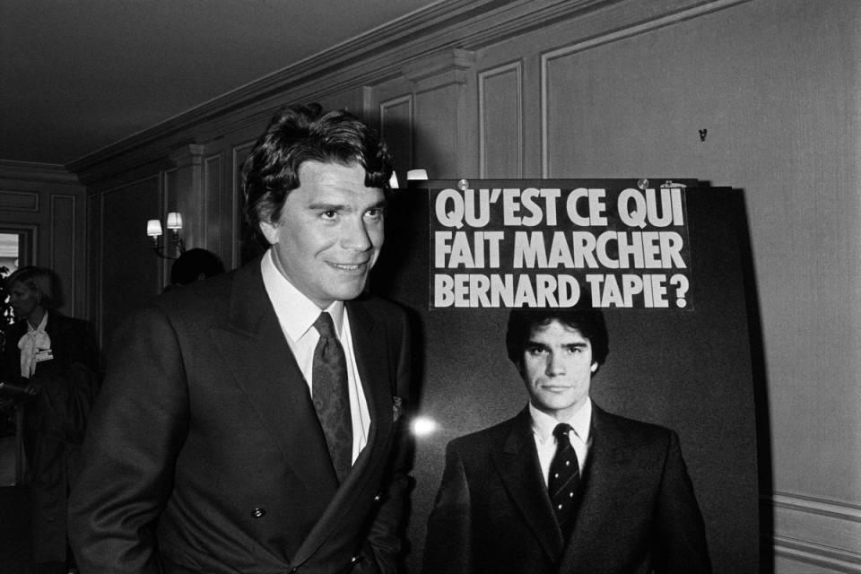 French businessman Bernard Tapie poses next to an advertising poster on 18 April 1986 in Paris (PASCAL GEORGE/AFP via Getty Images)