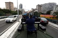 Pianist Rodrigo Cunha serenades from an open truck, in Sao Paulo