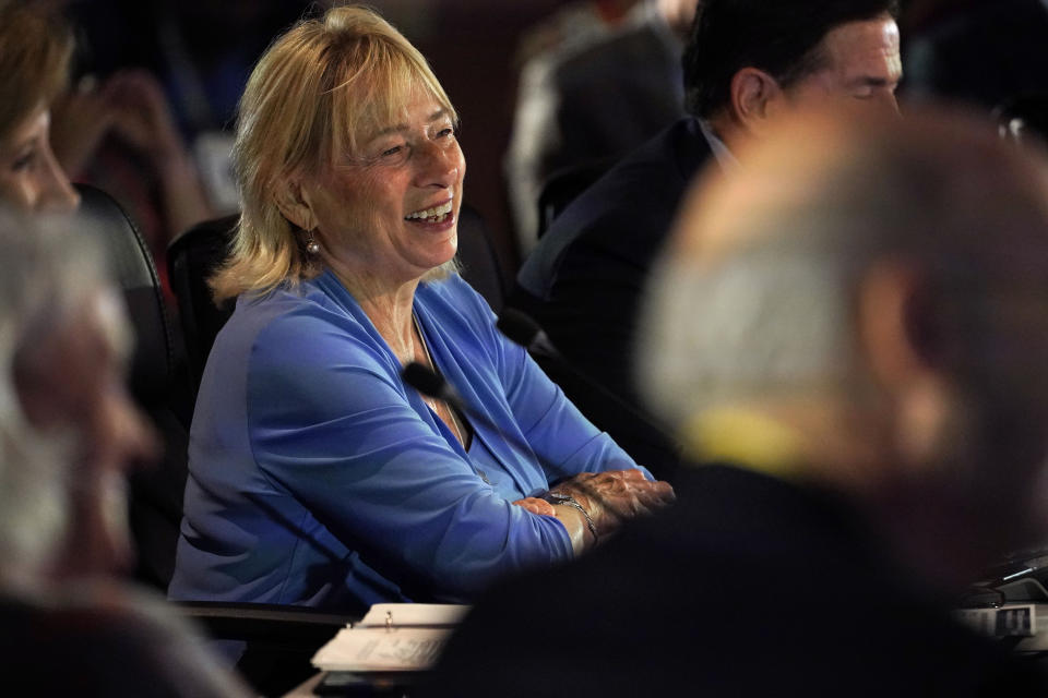 Maine Gov. Janet Mills laughs while talking with singer Dolly Parton via livestream during a panel discussion on literacy at the National Governors Association summer meeting, Friday, July 15, 2022, in Portland, Maine. (AP Photo/Robert F. Bukaty)