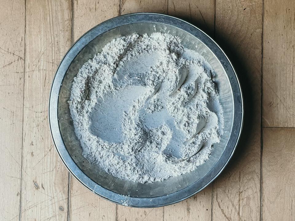 bowl of flour on a wooden surface