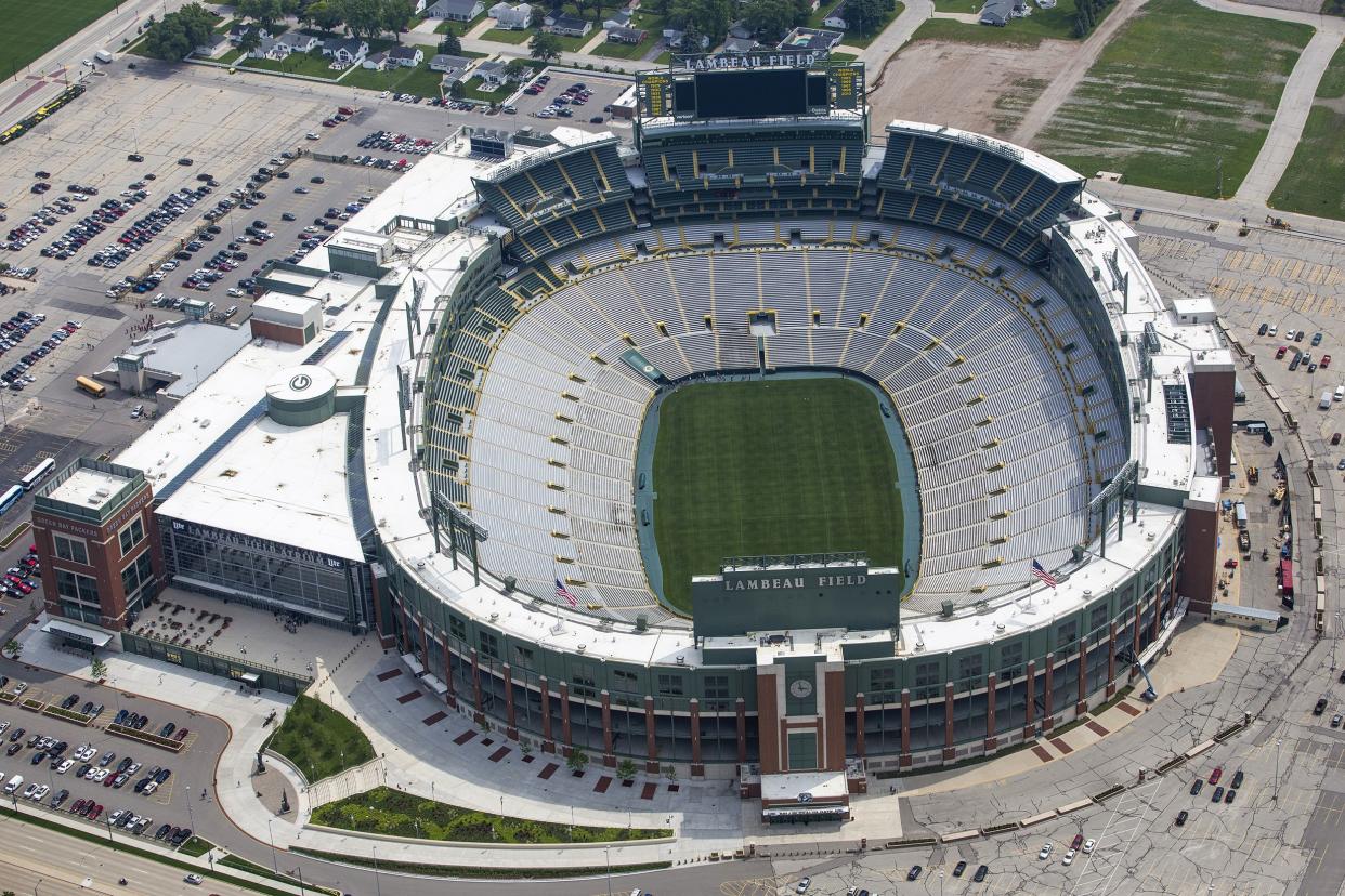 Green Bay Packers, Lambeau Field, Green Bay, Wisconsin, aerial with open field, empty field and seats, surrounded by a parking lot with a few cars