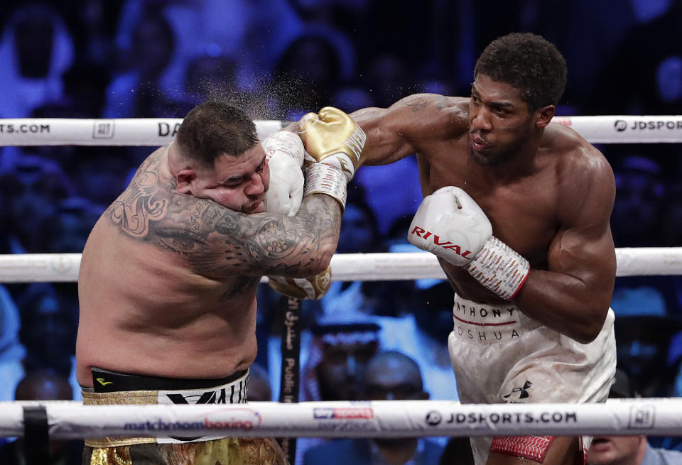 FILE - In this early Sunday Dec. 8, 2019, file photo, defending champion Andy Ruiz Jr., left, takes a right cross to the face during his fight against Britain's Anthony Joshua in their World Heavyweight Championship contest at the Diriyah Arena, Riyadh, Saudi Arabia. (AP Photo/Hassan Ammar, File)