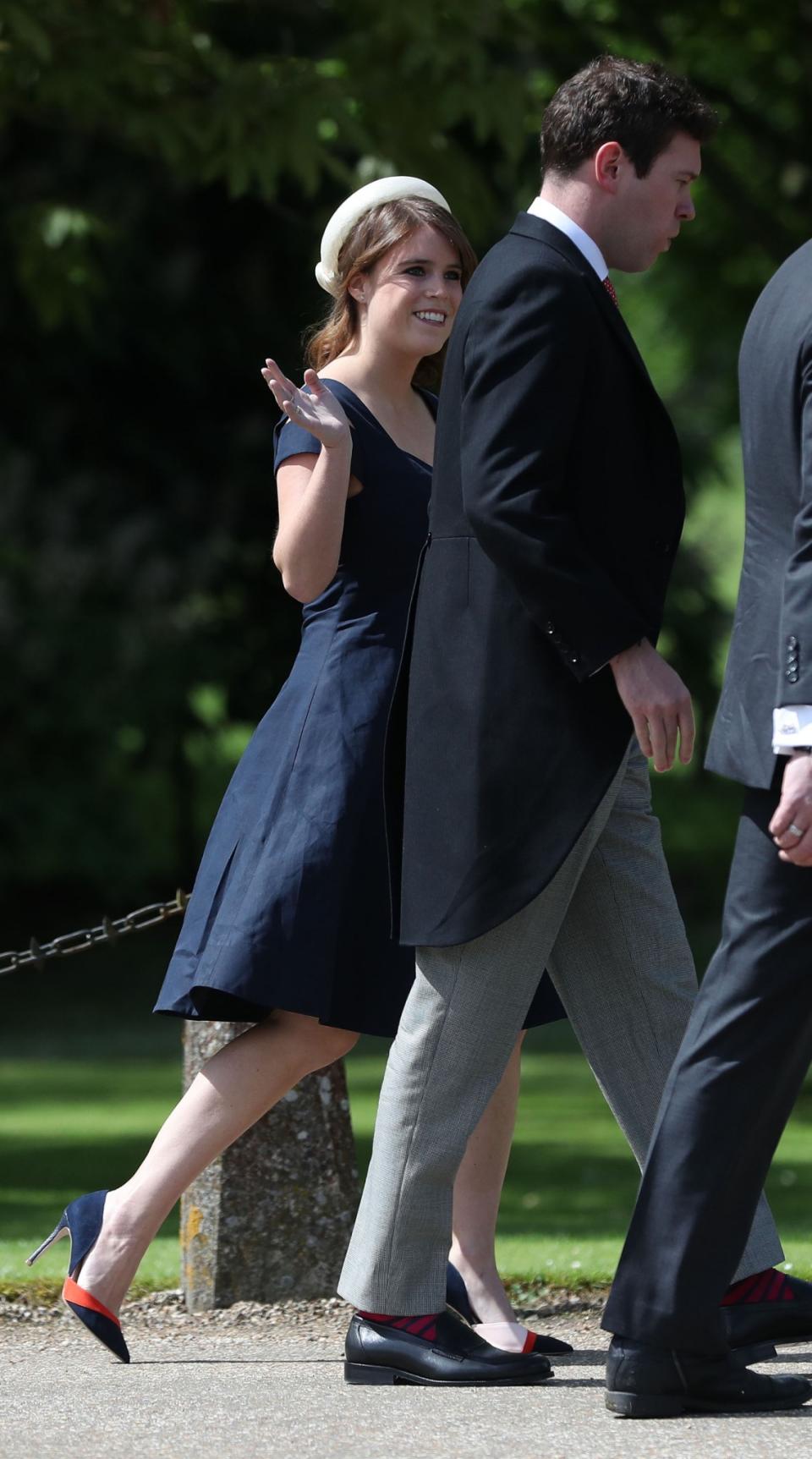 <p>The familiar royal face turned up with her partner Jack Brookbank. Eugenie ditched her usual eccentric look for a much more subtle navy dress with an elegant white hat. (Photo: PA) </p>