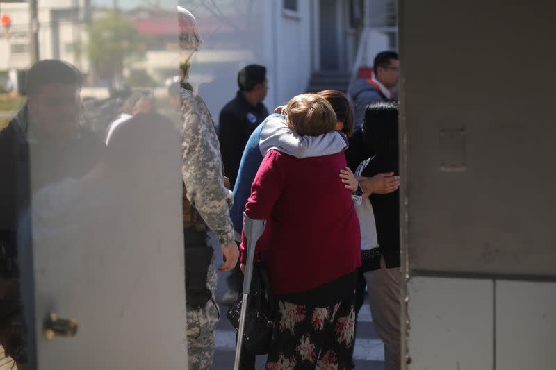 People react inside an air force base in Santiago