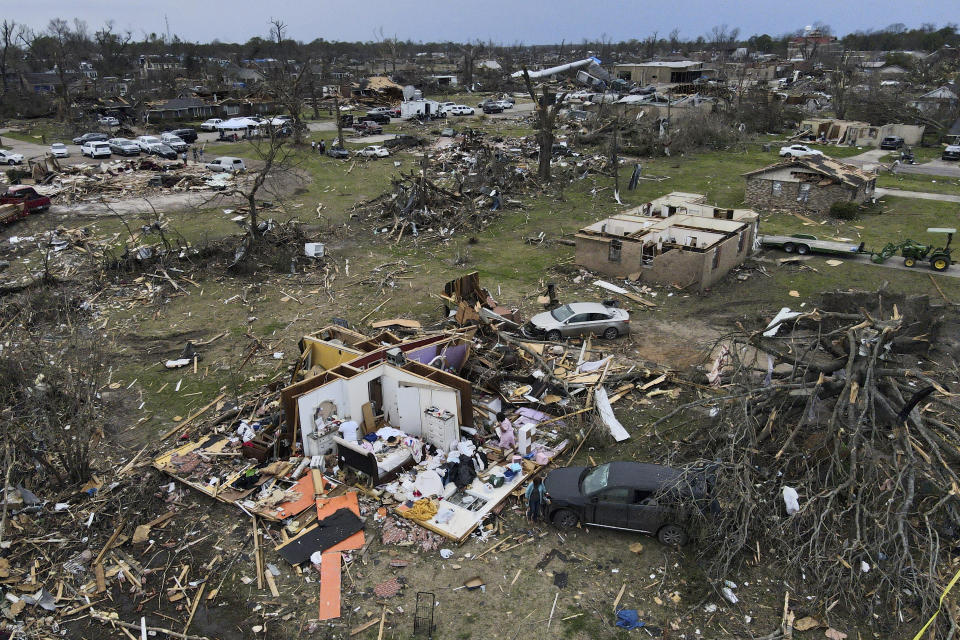 FILE - Debris is strewn about tornado damaged homes, Sunday, March 26, 2023, in Rolling Fork, Miss. President Joe Biden on Friday will visit a Mississippi town ravaged by a deadly tornado even as a new series of severe storms threatens to rip across the Midwest and South. (AP Photo/Julio Cortez, File)