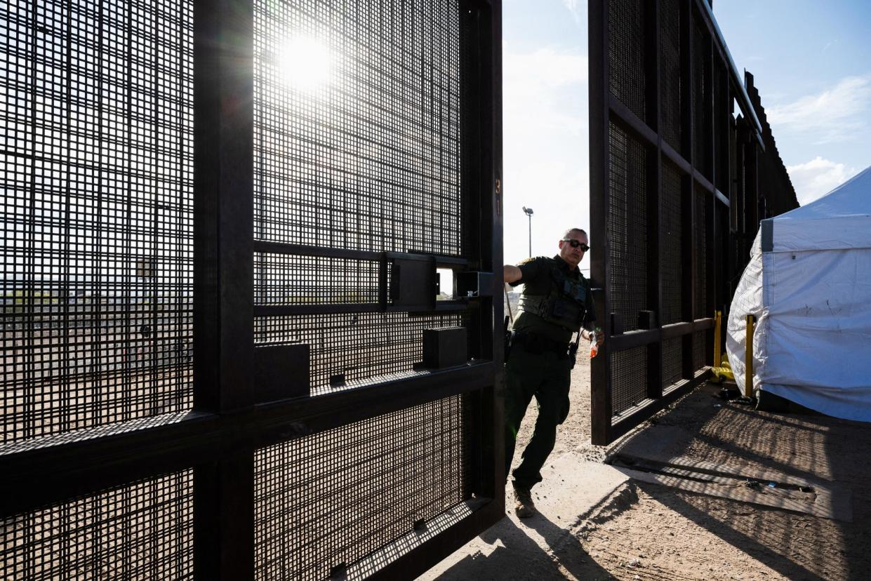 <span>A border patrol agent closes a gate in the border wall in El Paso, Texas, on Tuesday, after the supreme court let SB4 take effect.</span><span>Photograph: Justin Hamel/Reuters</span>
