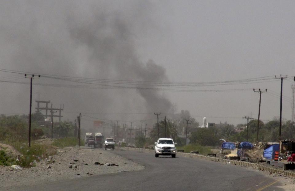 Smoke rises from a government building in al-Houta, the provincial capital of Yemen's southern Lahej province