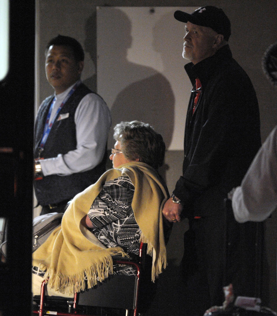 A passenger is pushed in a wheelchair to a waiting ambulance after the Carnival Triumph docked in Mobile, Ala., Thursday, Feb. 14, 2013. The ship with more than 4,200 passengers and crew members has been idled for nearly a week in the Gulf of Mexico following an engine room fire. (AP Photo/G M Andrews)