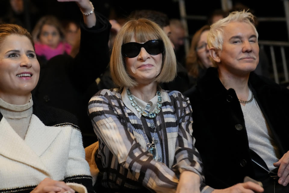 Anna Wintour, centre, Mirka Federer, left, and Baz Luhrmann are seen attending the Chanel Haute Couture Spring-Summer 2023 collection presented in Paris, Tuesday, Jan. 24, 2023. (AP Photo/Christophe Ena)