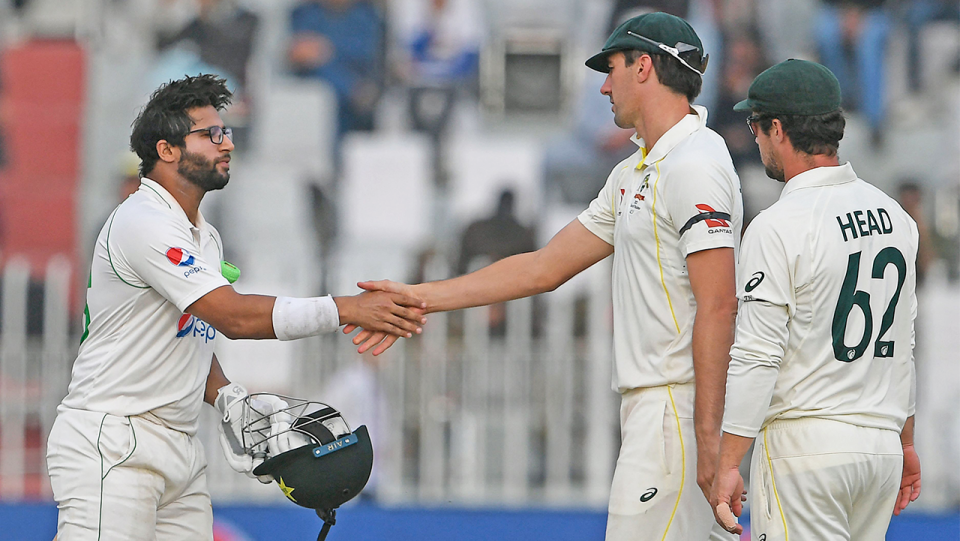 Pakistan's Imam-ul-Haq (pictured left) shakes hands with Australian captain Pat Cummins (pictured right) after the Test match.