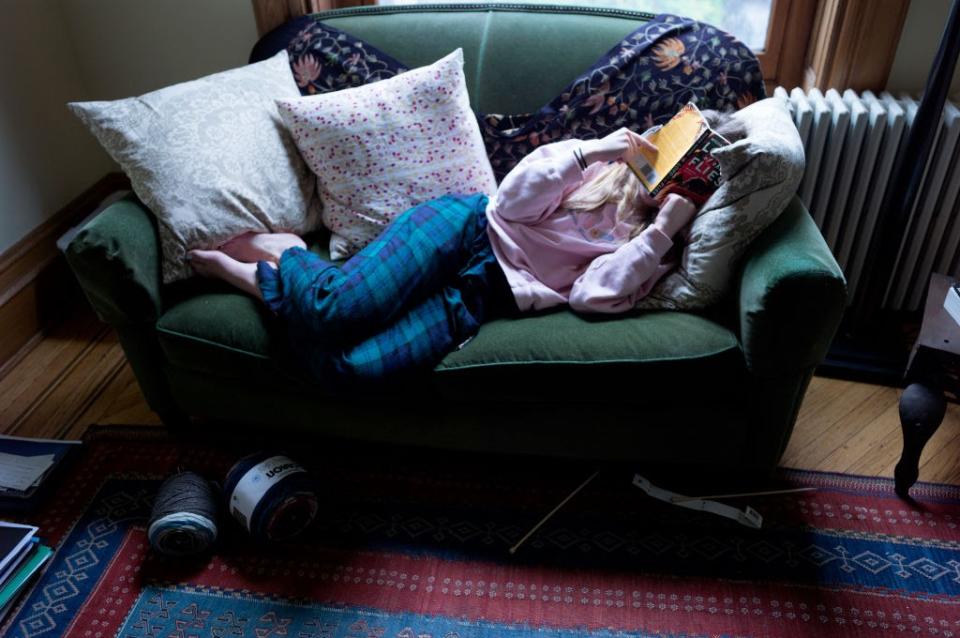 March 22: A teen reads a school English assignment at her Brooklyn home after her school shut down. (Getty Images)