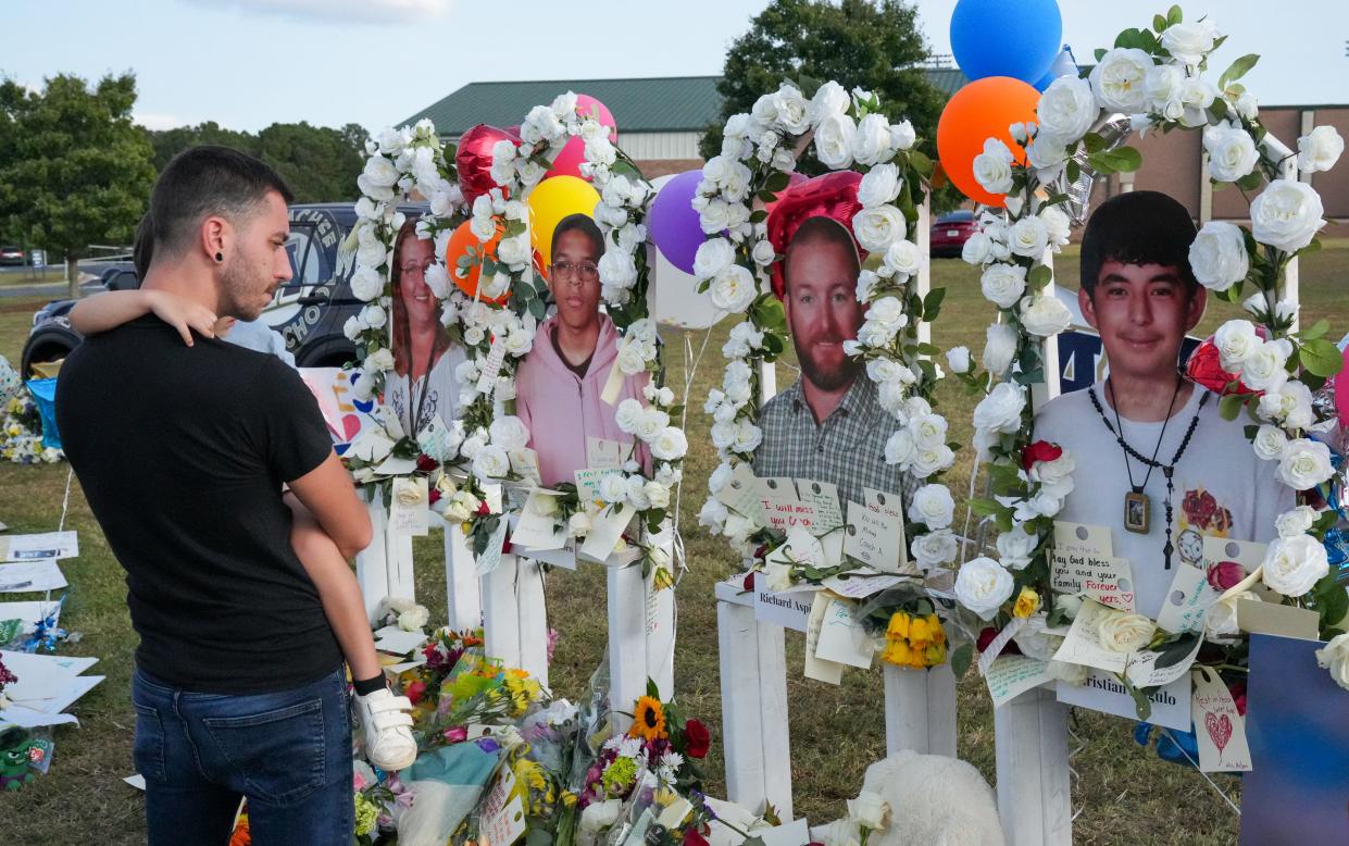 Mourners gather at Apalachee High School in Barrow County, Georgia, the evening before classes resumed across the district, less than a week after two teachers and two students were gunned down, investigators say, by a 14-year-old student.