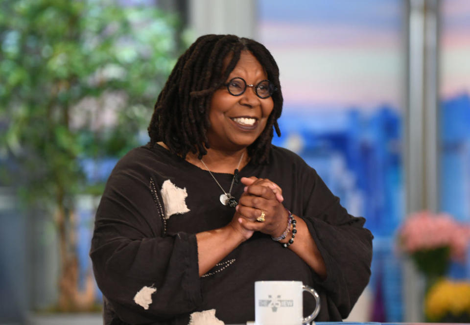 "The View" host smiling and clasping her hands together
