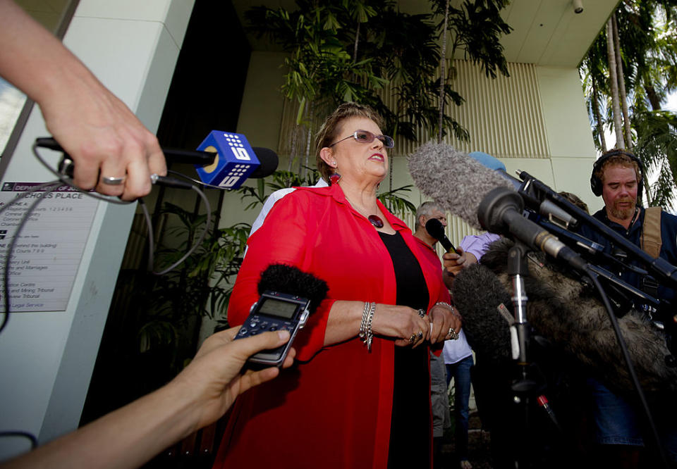 she's standing outside a courthouse talking to media