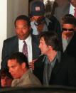 <p>O.J. Simpson, left, leaves Los Angeles County Superior Court in Santa Monica, Calif., after the verdict in the wrongful death civil suit against him Tuesday, Feb. 4, 1997. Simpson was found liable on all counts. (Photo: Michael Caulfield/AP) </p>