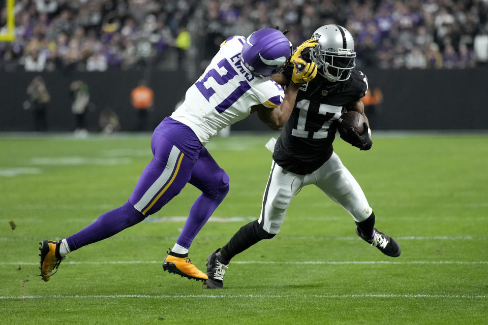 Las Vegas Raiders wide receiver Davante Adams (17) is tackled by Minnesota Vikings cornerback Akayleb Evans (21) during the second half of an NFL football game, Sunday, Dec. 10, 2023, in Las Vegas. (AP Photo/John Locher)