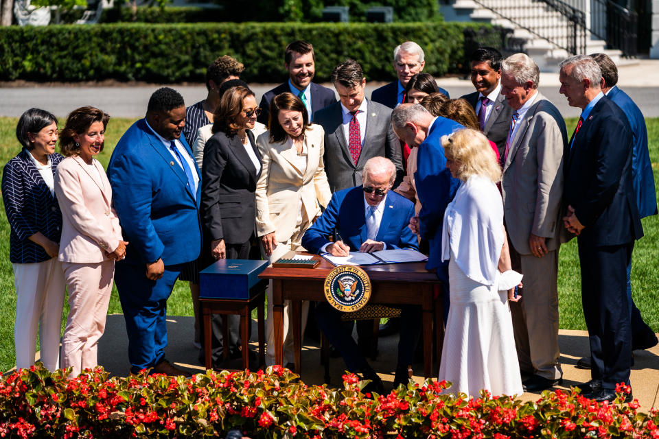 WASHINGTON, DC  August 9, 2022:

US President Joe Biden signs into law the CHIPS and Science Act of 2022, on the South Lawn of the White House in Washington, Tuesday, August 9, 2022. Left to right: Founder and CEO of SparkCharge Joshua Aviv, US President Joe Biden, Speaker of the House Nancy Pelosi (D-CA) and Secretary of Commerce Gina Raimondo. 
(Photo by Demetrius Freeman/The Washington Post via Getty Images)