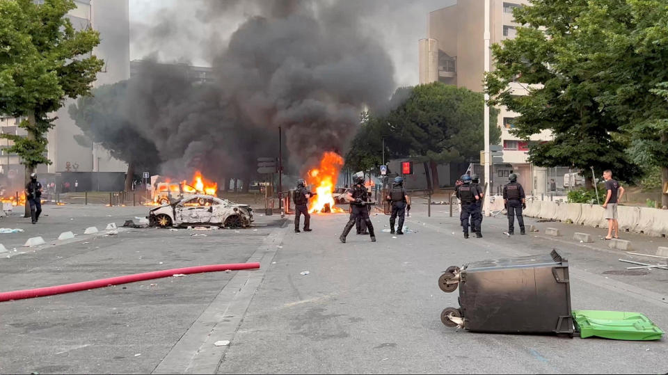 Cars burn in the aftermath of clashes between protesters and police following the death of Nahel, a 17-year-old teenager killed by a French police in Nanterre during a traffic stop, in Toulouse, France, June 28, 2023. / Credit: Timothee Forget/via REUTERS