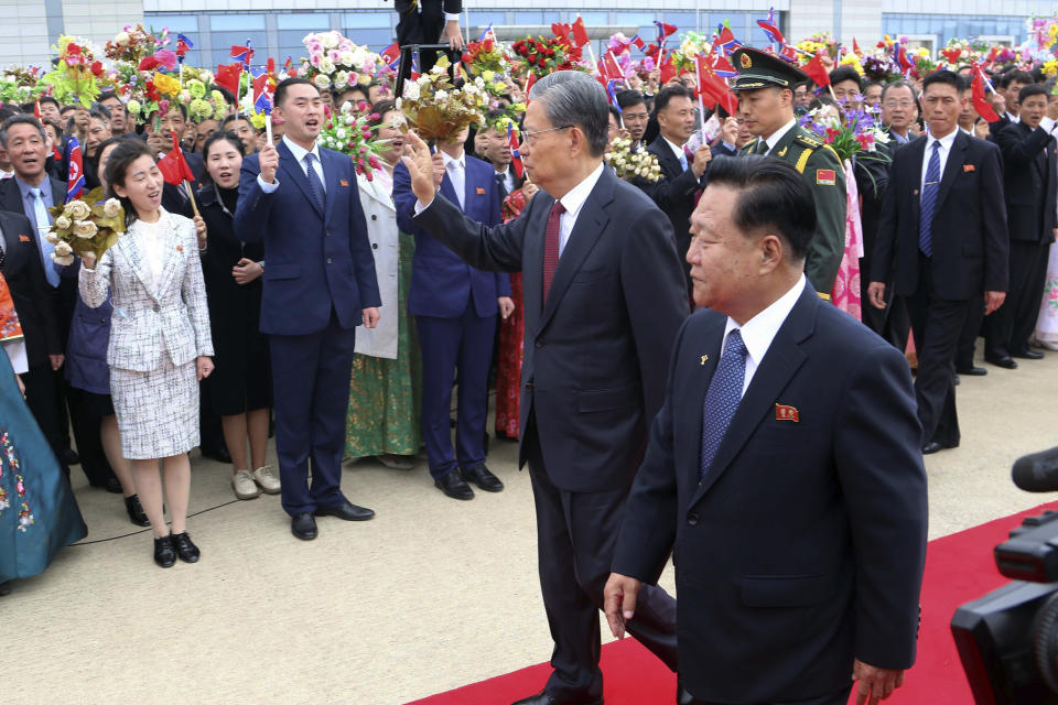 Zhao Leji, center, chairman of the National People’s Congress and considered the No. 3 official in the ruling Communist Party, waves as Choe Ryong Hae, front right, vice-chairman of the central committee of the Workers' Party of North Korea, and Pyongyang citizens welcome Zhao and other delegates upon their arrival at the Pyongyang International Airport in Pyongyang, North Korea, Thursday, April 11, 2024. (AP Photo/Cha Song Ho)