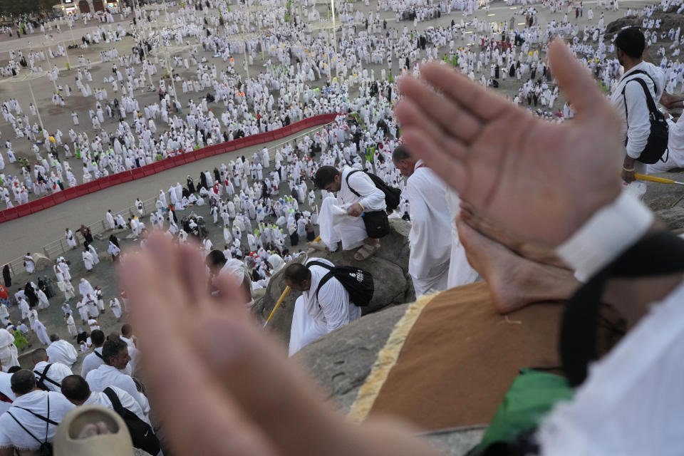 Muslim pilgrims gather at top of the rocky hill known as the Mountain of Mercy, on the Plain of Arafat, during the annual Hajj pilgrimage, near the holy city of Mecca, Saudi Arabia, Saturday, June 15, 2024. Masses of Muslims gathered at the sacred hill of Mount Arafat in Saudi Arabia for worship and reflection on the second day of the Hajj pilgrimage. The ritual at Mount Arafat, known as the hill of mercy, is considered the peak of the Hajj. It's often the most memorable event for pilgrims, who stand shoulder to shoulder, asking God for mercy, blessings, prosperity and good health. Hajj is one of the largest religious gatherings on earth.(AP Photo/Rafiq Maqbool)